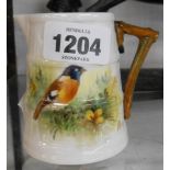 A small Royal Worcester cream jug with hand painted Stonechat decoration - signed