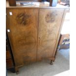 A 69cm 1930's walnut veneered two door cabinet by Raleigh Furniture, set on short cabriole legs with