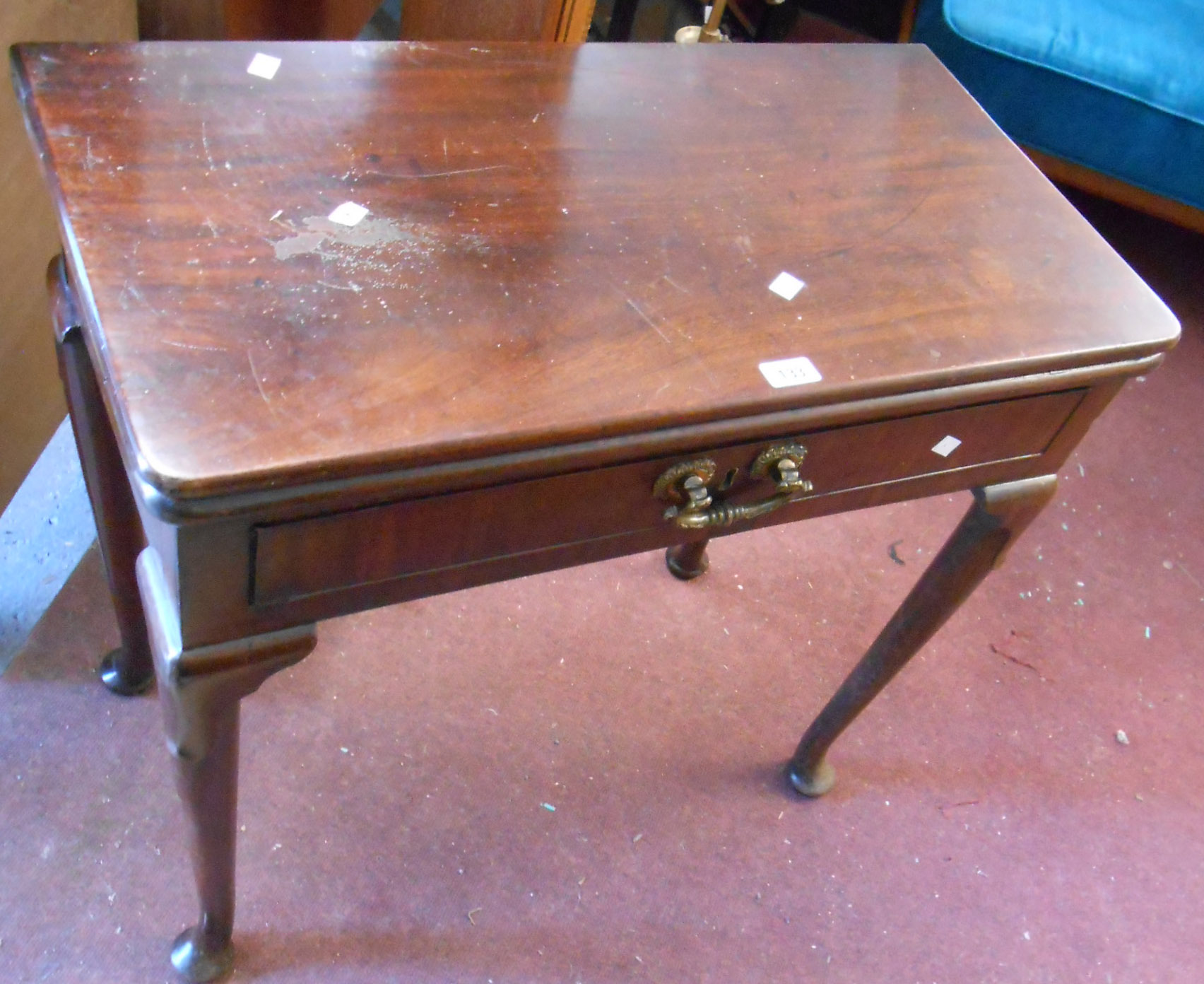 A 77cm late Georgian mahogany fold-over card table with baize inset top, single frieze drawer with