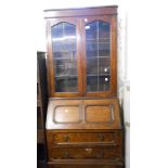 A 76cm vintage oak two part bureau/bookcase with glazed top section over a part fitted interior