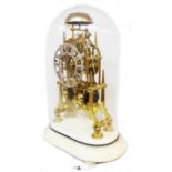 A 36cm high brass skeleton clock of cathedral design with brushed metal pierced dial, metal bell and