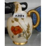 A small Royal Worcester porcelain jug of helmet form decorated with hand painted floral sprays