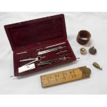 A bag containing a vintage cased drawing instrument set, boxwood folding rule, etc. - sold with a