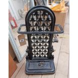 A Victorian cast iron stick stand with pierced back and removable drip tray with later black painted