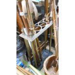 A brass four hole stick stand, set on a cast iron base with both drip trays