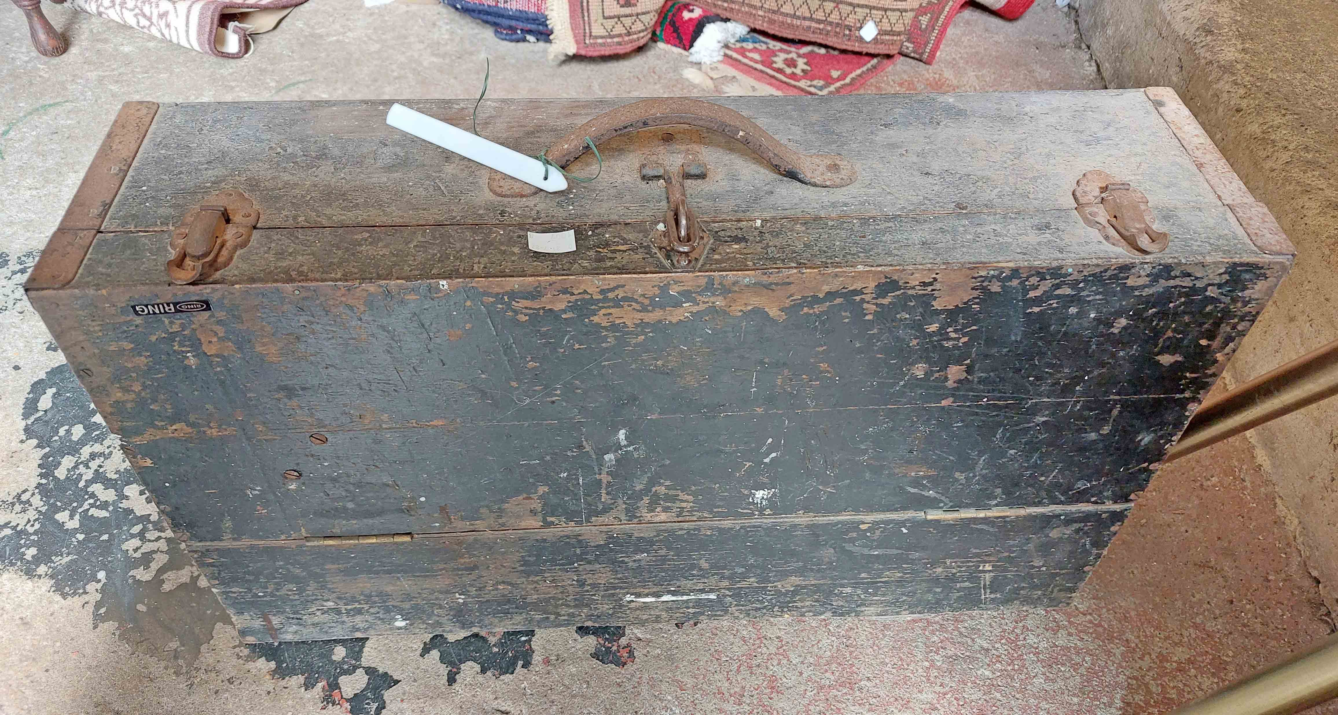 An old painted mixed wood carpenter's tool chest with drawer fitted interior containing a quantity