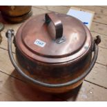 A large Victorian copper cooking pot and lid with wrought iron handle