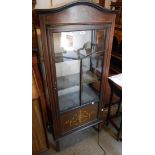 A 61cm Edwardian inlaid mahogany dome-top display cabinet with material lined interior enclosed by a