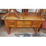 A 1.2m stained mixed wood coffee table conversion with drawers and cupboard doors, set on turned