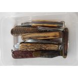 A tub containing a quantity of old folding penknives including antler and horn handled examples,