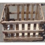 A rustic slatted wood log crate