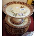 A continental porcelain part dessert set comprising ten plates and one comport decorated with hand