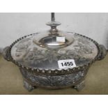 A large Meriden silver plated serving dish and cover with embossed and engraved decoration, flanking