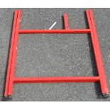 A red Logmate folding sawhorse