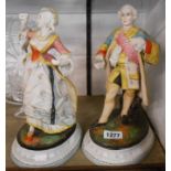 A pair of late 19th Century French painted bisque porcelain figurines depicting a lady and gentleman