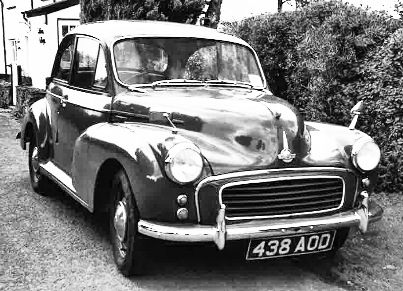 A 1959 Morris Minor 1000 saloon car in restored condition and grey livery with burgundy red