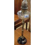 A Victorian oil lamp with reeded brass candlestick pillar, clear glass slice cut reservoir set on