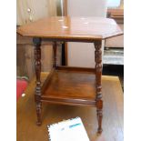 A 50cm Edwardian walnut two tier occasional table with canted top, set on turned supports