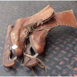 A pair of lady's old leather lace up boot ice skates