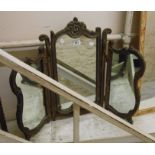 A vintage ornate antiqued gilt framed triple dressing table mirror with shaped plates