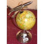 A modern Art Deco style globe with aeroplane finial