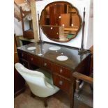 A 1.14m 20th Century mahogany dressing table with central swing mirror with shaped bevelled plate,