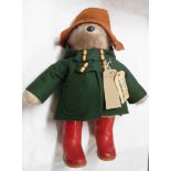 A 1970's Gabriel Designs Paddington Bear soft toy with green felt duffle coat, brown hat, red Dunlop