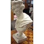 A plaster bust of a classical figure set on small marble plinth