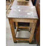 A 43cm rustic pine and mixed wood printer's table, set on square supports