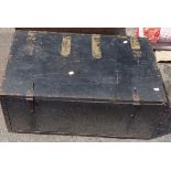 A vintage black painted wood trunk with flanking rope handles
