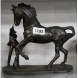 A Heredites resin figurine with bronze effect finish depicting a young girl with a skittish horse