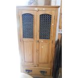 A 93cm modern pine wardrobe with hanging space enclosed by a pair of decorative cast and pierced