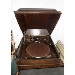 An old wooden cased HMV table gramophone (water damage to one side) - sold with a box containing a