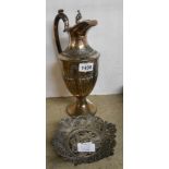 A silver plated wine ewer - sold with an ornate white metal filigree coaster