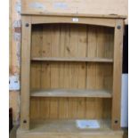 An 83cm modern pine three shelf open bookcase with iron studded corners, set on plinth base