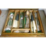An oak canteen containing an associated six place setting of silver plated fiddle pattern cutlery