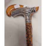 An antique walking stick with carved textured cane and decorative hallmarked silver reeded