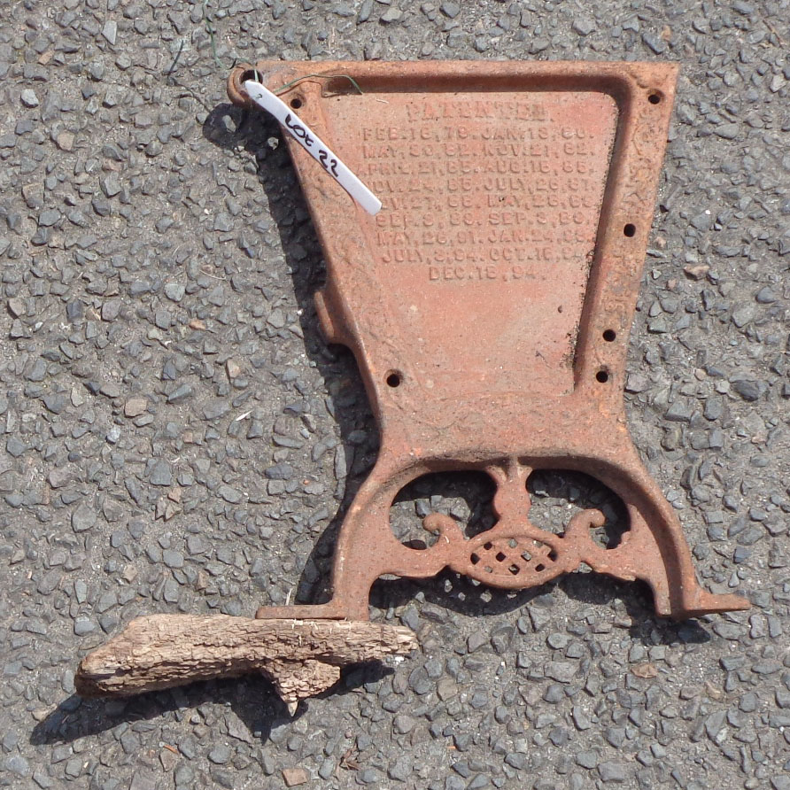 A pair of old cast iron panels from a Superior Double Force Feed Grain Drill