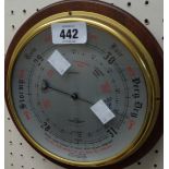 A vintage oak cased circular wall barometer by Shortland Brothers with aneroid works