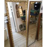 A gilt framed narrow oblong wall mirror with decorative border - sold with a vintage stained wood