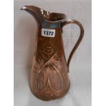 A Joseph Sankey & Sons embossed copper jug decorated in the Art Nouveau style