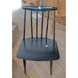 A set of six Danish retro black painted stick back dining chairs with moulded top rails, set on