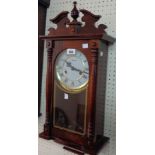 A reproduction Lincoln stained wood cased Vienna style wall clock with visible pendulum, detached