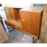 A 1.5m retro teak effect Nathan sideboard with central frieze drawers and open glass shelves,