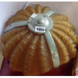 An Art Deco hanging ceiling light with three moulded amber glass shell form shades and a