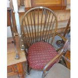 A vintage Ercol dark elm hoop stick back rocking chair