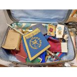 A suitcase containing a large quantity of Masonic regalia including aprons, jewels, books,