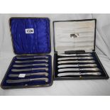 A cased set of six silver pistol grip handled butter knives - sold with another set of silver