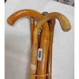 A selection of walking canes of various design including two silver topped examples, etc.