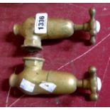 A pair of antique brass taps with inset porcelain HOT and COLD tabs